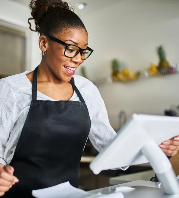 Happy restaurant owner using POS ordering terminal