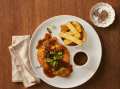 A perfectly crumbed chicken schnitzel, plated on a bed of lusciously silky and creamy Maggi Mash with coleslaw and a lemon we